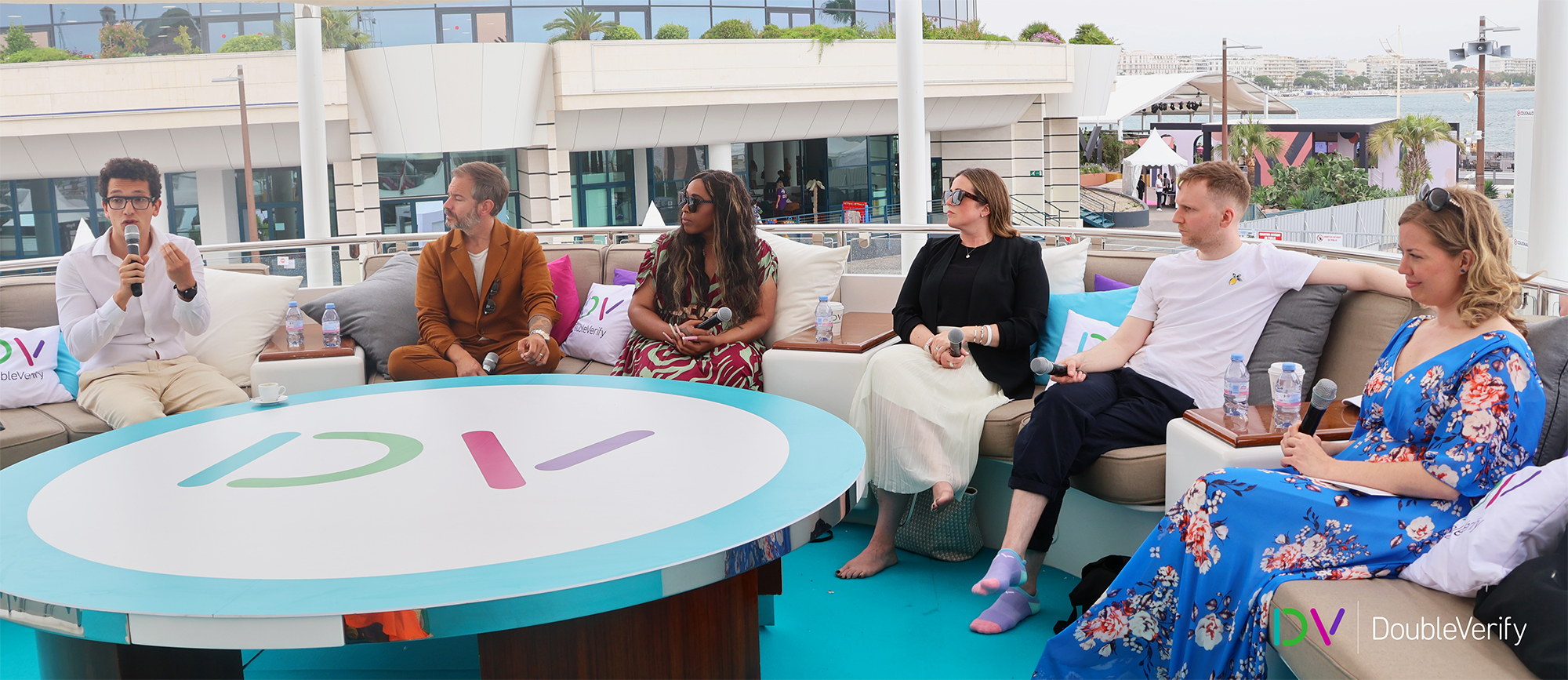 Photo taken on DV's yacht at the 2024 Cannes Lions International Festival of Creativity showing six panel members holding microphones and engaging in discussion.