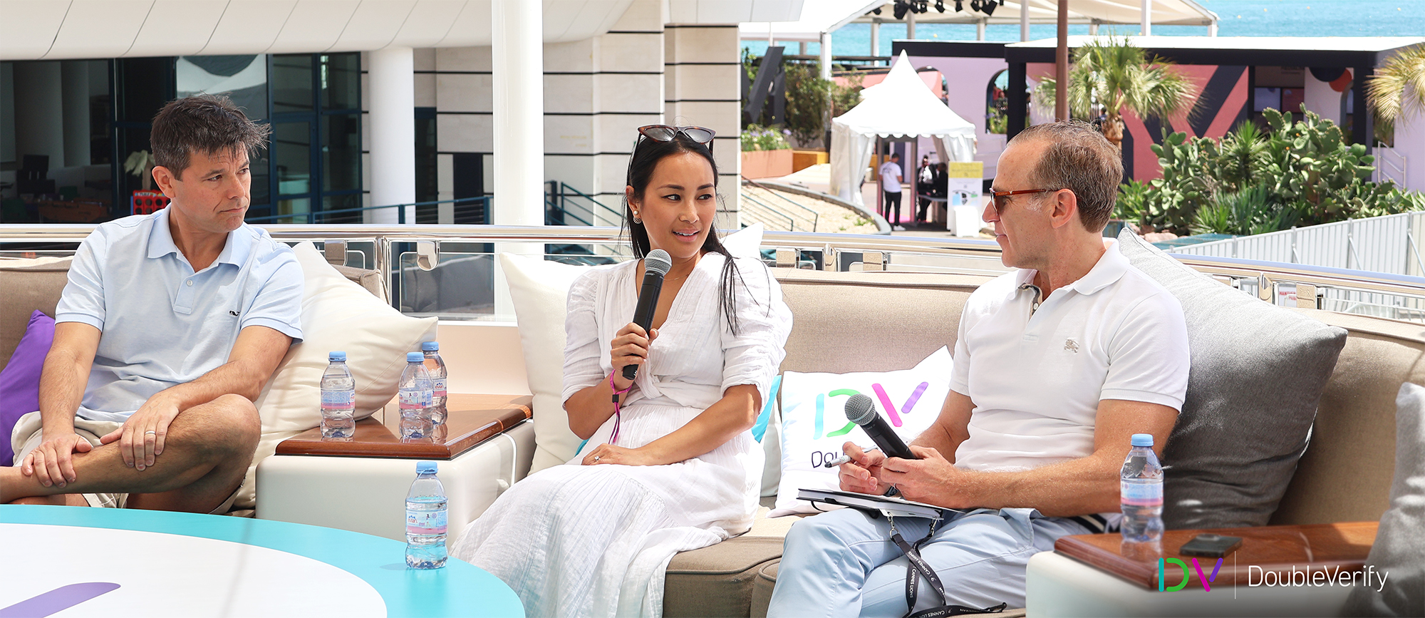 Photo taken on DV's yacht at the 2024 Cannes Lions International Festival of Creativity showing three panel members, including DV CEO Mark Zagorski, holding microphones and engaging in discussion.